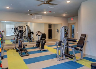 Newsome Homes Fitness center with a mirror wall